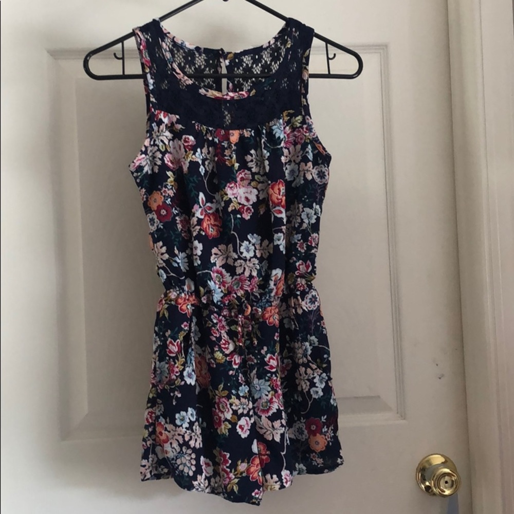A navy romper with pretty flower designs